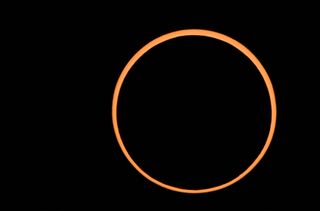 an orange ring of light against a black background.