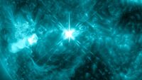 a bright flare of light on a wavy, fuzzy-looking background